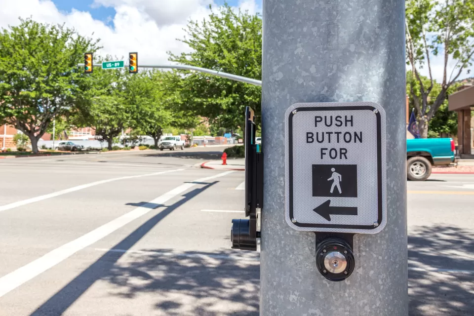 CLose-up of pedestrian call button on pole at intersection